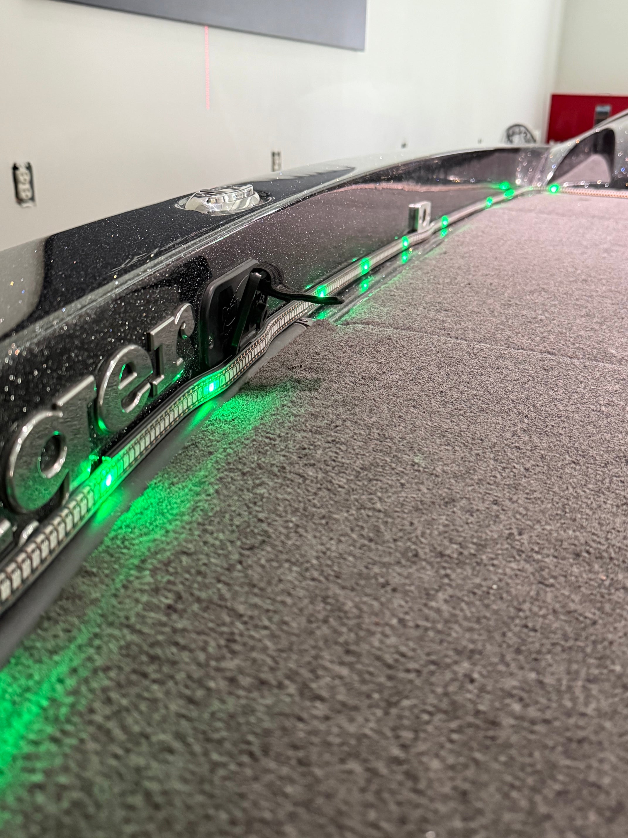 Close-up of the BeamSync LED strip lit green in its extrusion along the boat's gunwale